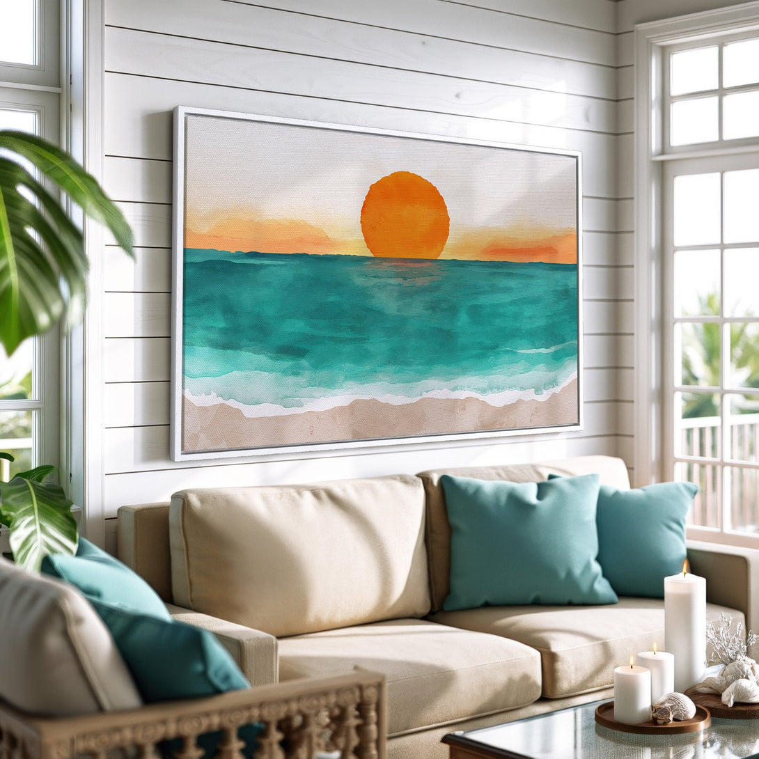 Framed Wall Art: Watercolor sunset Canvas Print in a coastal living room. Features vibrant orange, teal, and beige tones for a serene beach vibe.