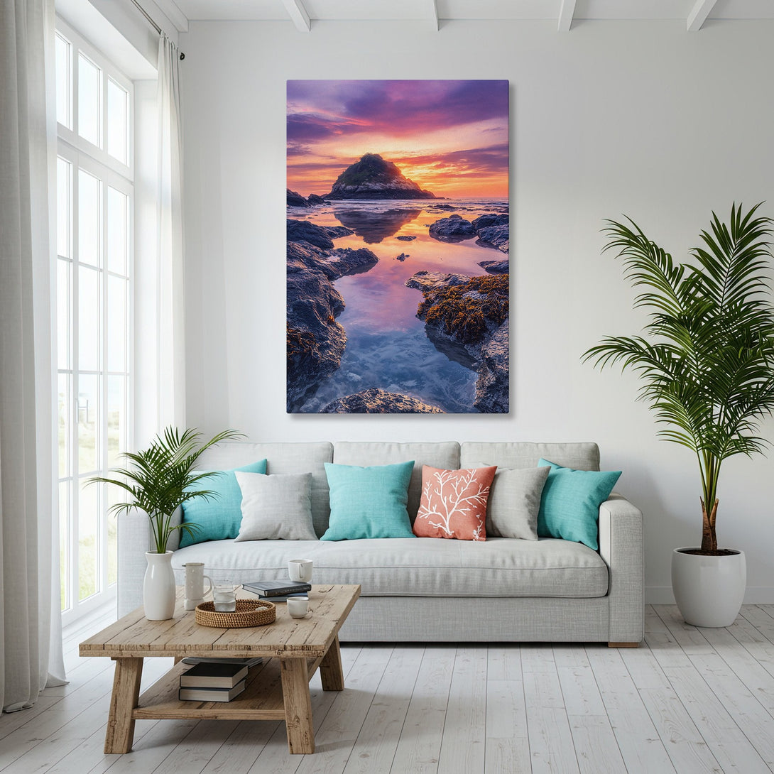 Framed Wall Art: Coastal sunset canvas print in a modern living room. Warm orange and purple hues complement the blue ocean view. Elevate your space!