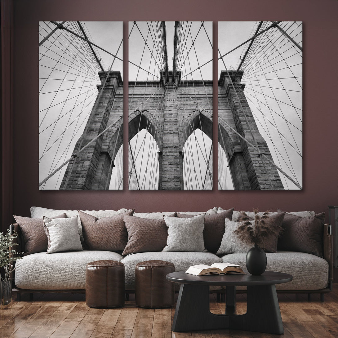 Canvas Print of the Brooklyn Bridge in black and white, a classic architectural photo in a modern living room setting.