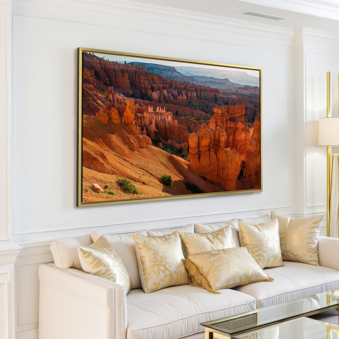 Canvas Print of Bryce Canyon landscape in warm orange and blue tones, displayed in a modern living room.