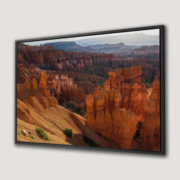 Framed Wall Art: Stunning Bryce Canyon landscape Canvas Print. Warm orange and red hues create a breathtaking view of the natural rock formations. Bring the outdoors in!