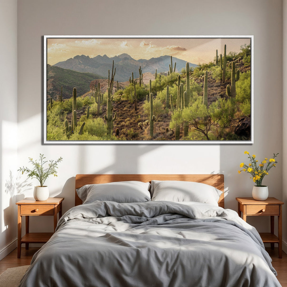 Framed Wall Art of a desert landscape with cacti and mountains. Earthy tones of green, brown, and gold. Perfect for adding a touch of nature to your bedroom.