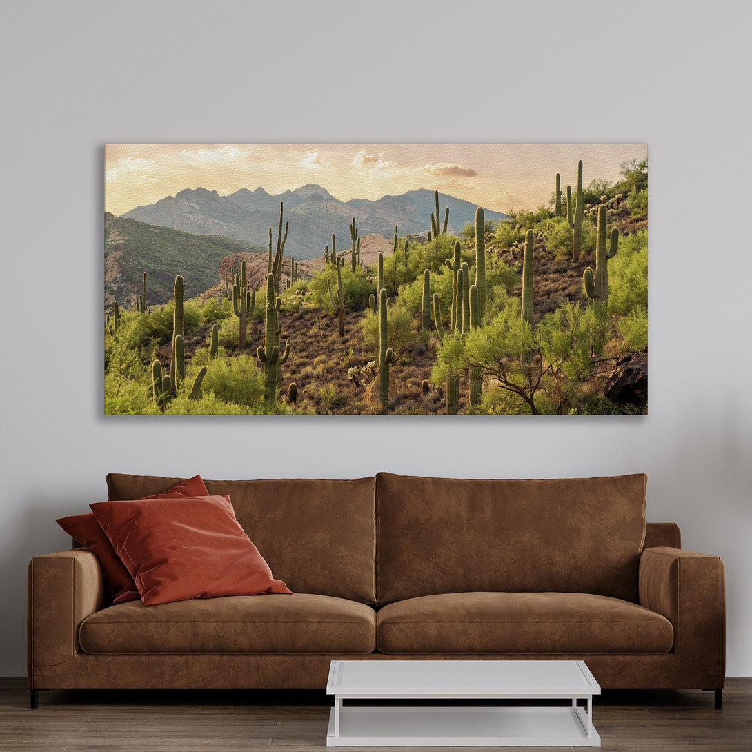 Framed Wall Art: Desert landscape Canvas Print with cacti and mountains. Earthy tones of green, brown, and gold create a warm, inviting atmosphere.
