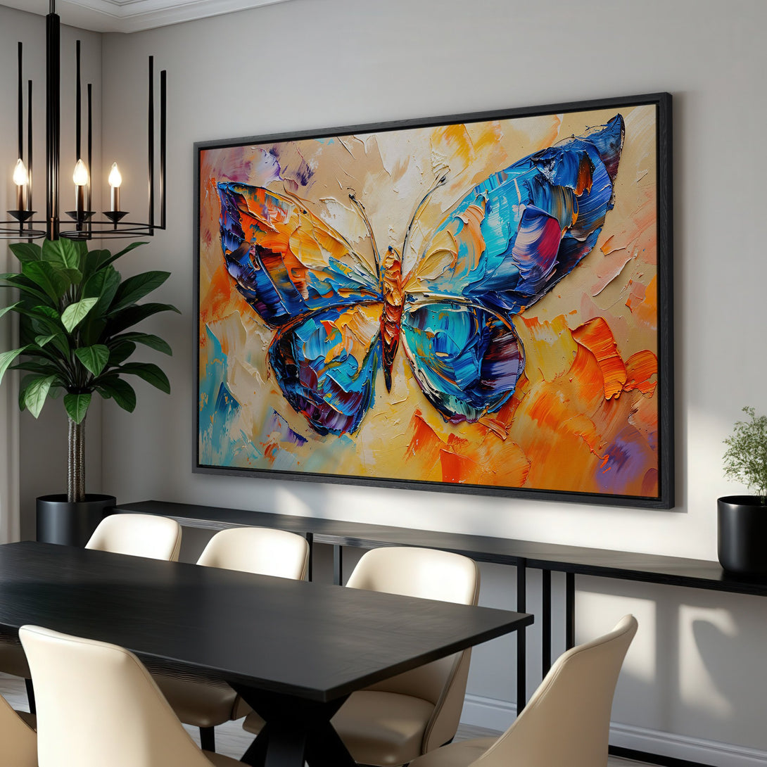 Framed Wall Art: Vibrant butterfly painting in an abstract style. Features a bold blue, orange, and yellow color palette. Perfect for adding art to your dining room!