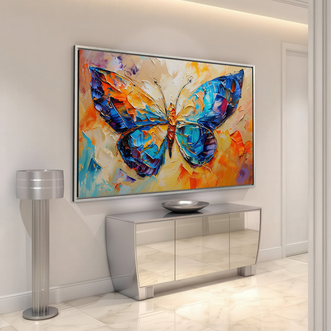 Framed Wall Art: Vibrant butterfly painting in a modern interior. Bold impasto style with a colorful palette of blue, orange, and yellow. Perfect wall decor!