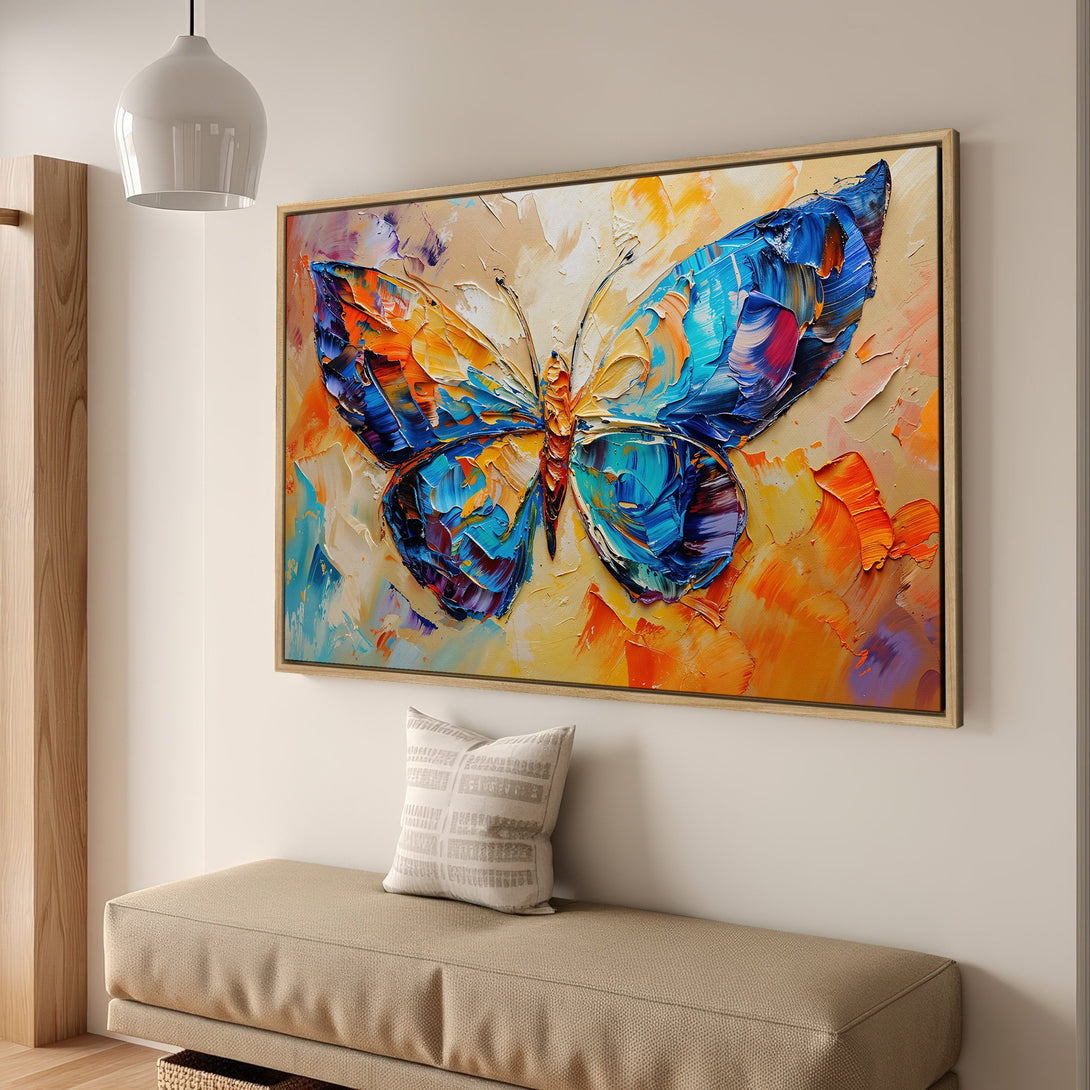 Framed Wall Art: Abstract butterfly painting in vibrant blue, orange, and yellow. Textured brushstrokes create a modern, colorful statement piece for your home.