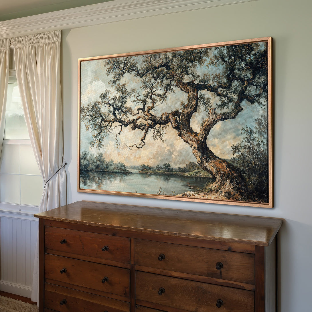 Framed Wall Art featuring a landscape painting with a large tree, in a muted blue and brown color palette, perfect for any home decor.