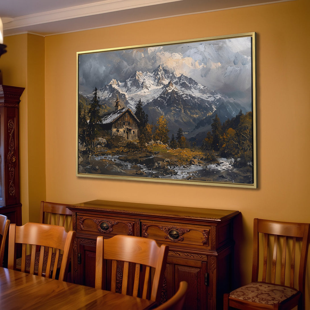 Canvas Print of a mountain landscape painting in a warm, neutral interior. Features a cabin, snowy peaks, and a muted, earthy color palette.