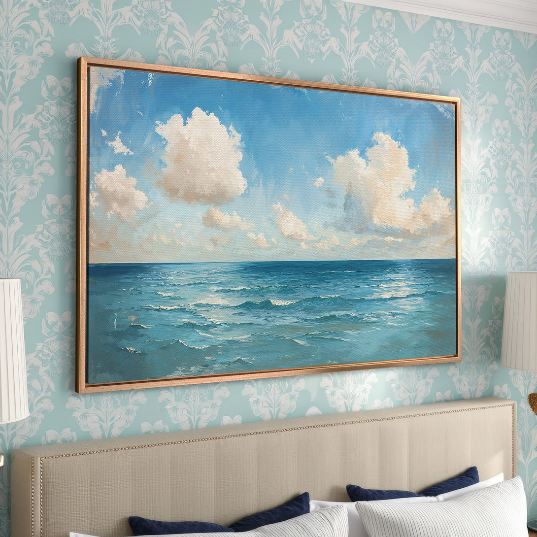 Framed Wall Art: Ocean view canvas print in a gold frame. Coastal art with blue, white, and beige tones, perfect for bedroom decor.