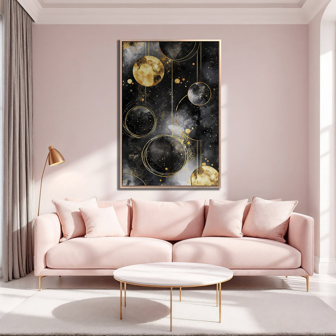 Framed Wall Art: Abstract black and gold art print in a modern living room. Features a celestial design with a blush pink and gold color palette.