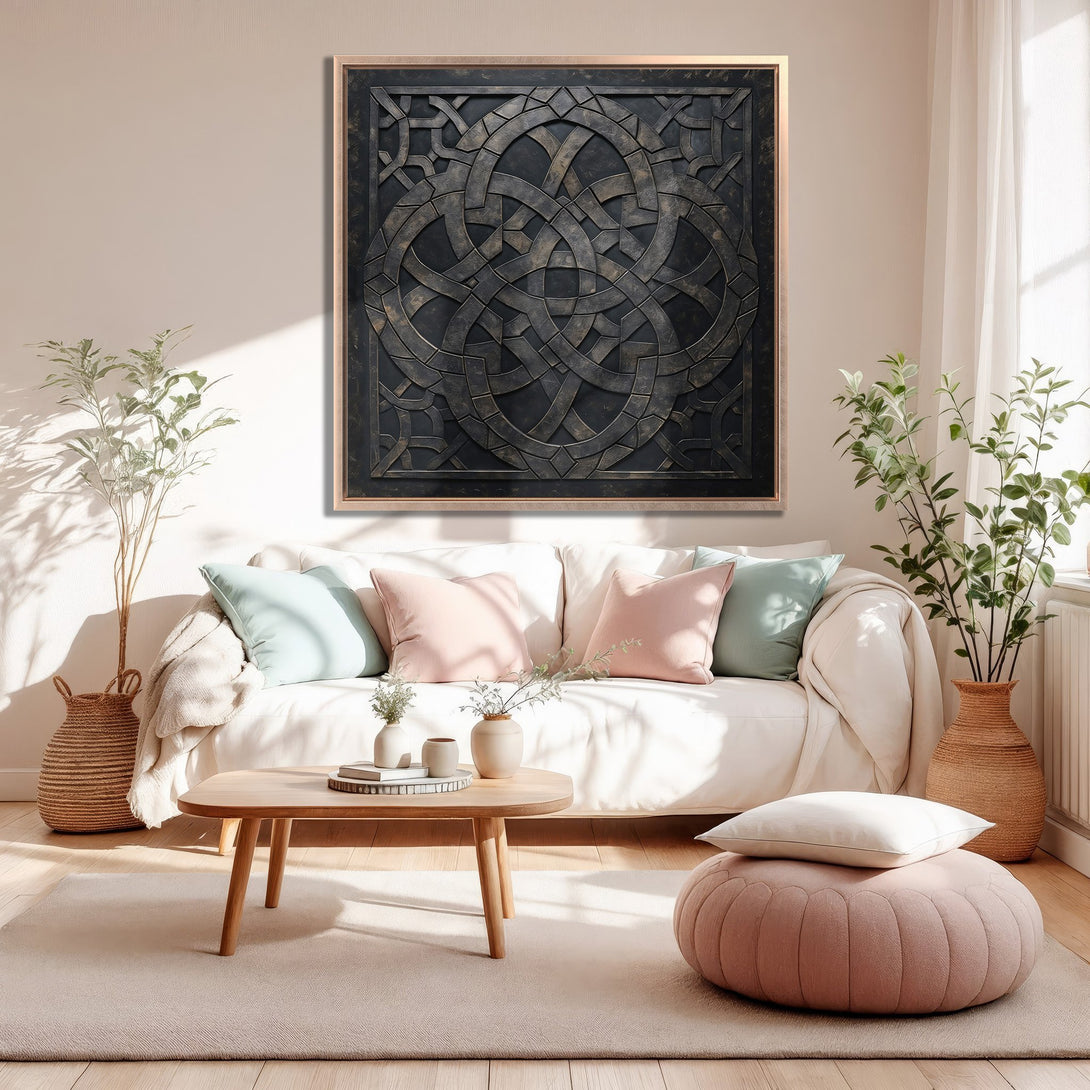 Framed Wall Art in a modern living room. Dark geometric design with bronze frame, neutral palette with pops of pink and blue.