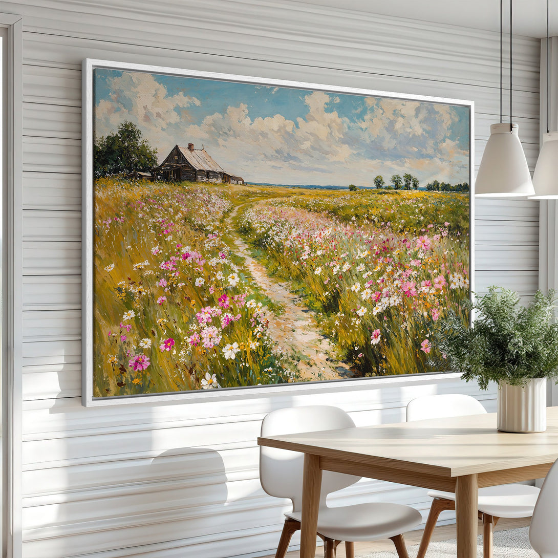 Framed Wall Art: Landscape painting of a wildflower field with a rustic cabin. Warm, vibrant colors of pink, yellow, and blue create a serene atmosphere.