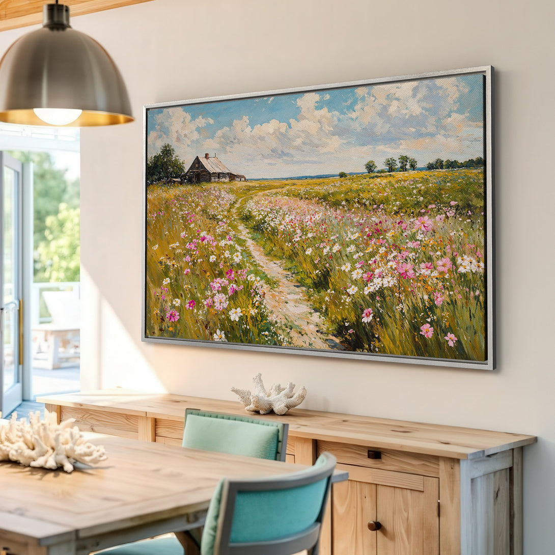Framed Wall Art Canvas Print: Impressionist landscape painting of a field with a path, featuring a rustic cabin. Earthy tones with pops of pink and blue.