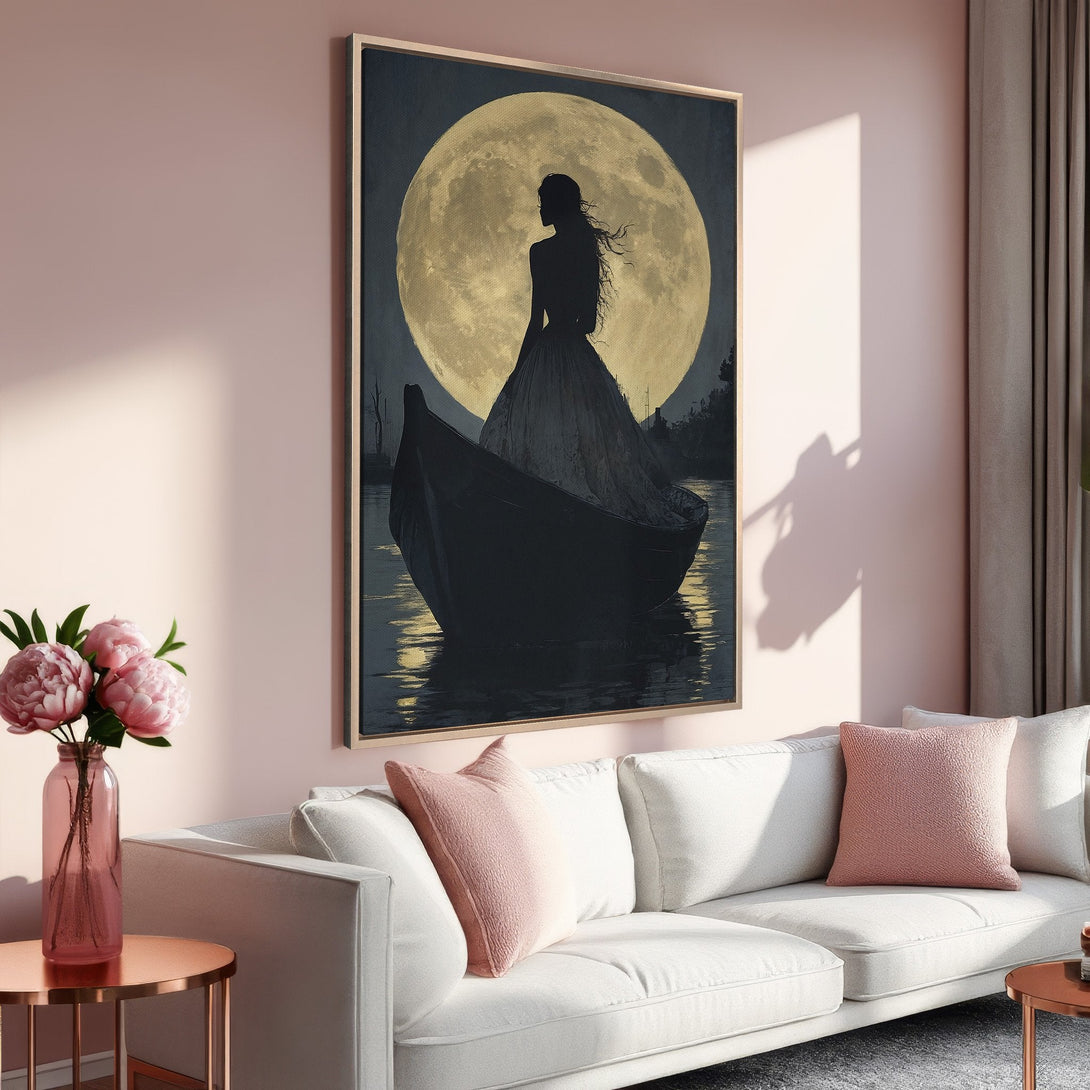 Framed Wall Art featuring a woman in a boat silhouetted against a moon. Moody, romantic style with a pink and gold color palette. Perfect for any living room.