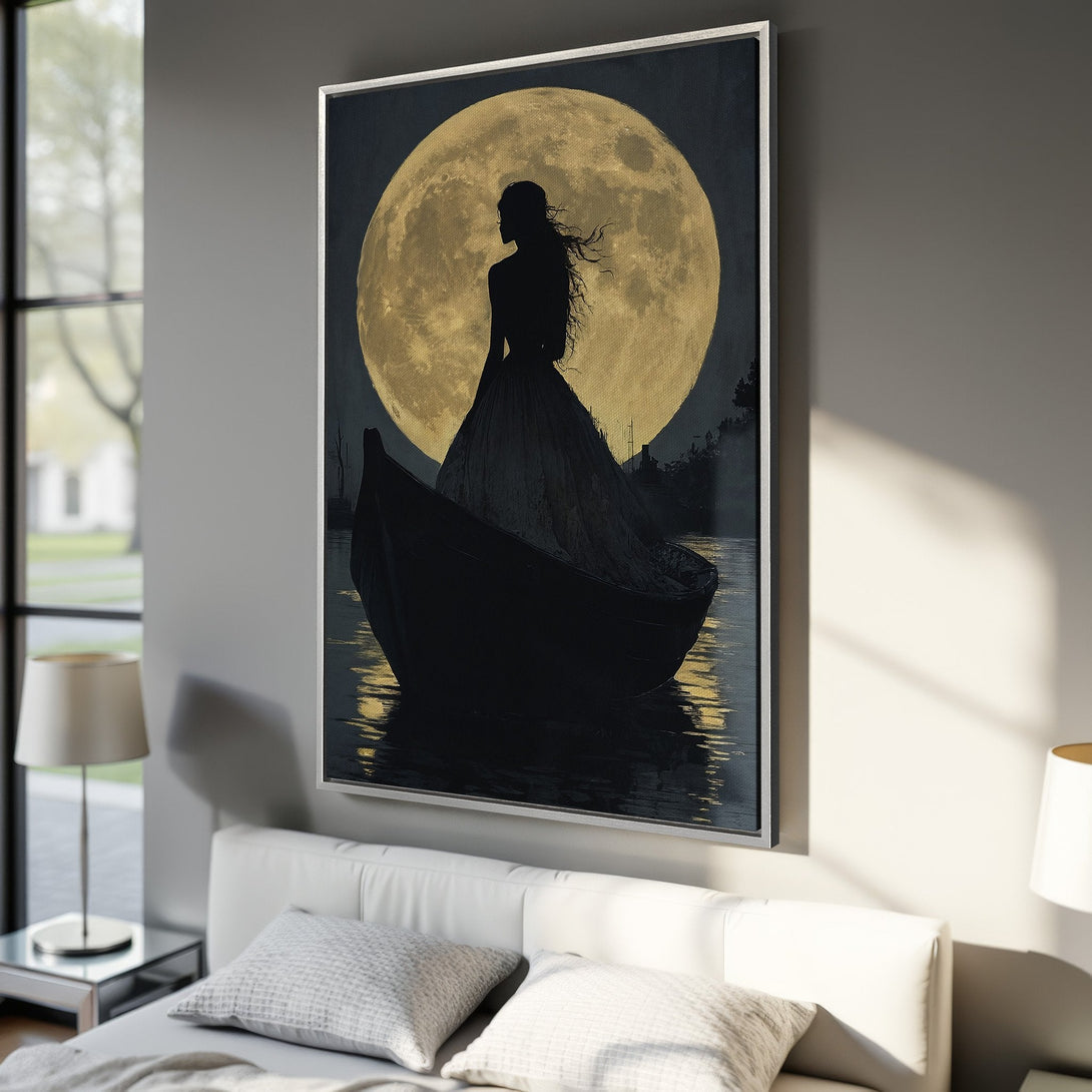 Framed Wall Art: Silhouette of woman in boat against a golden moon. Moody, romantic artwork with a dark, gold, and neutral color palette. Perfect bedroom decor.