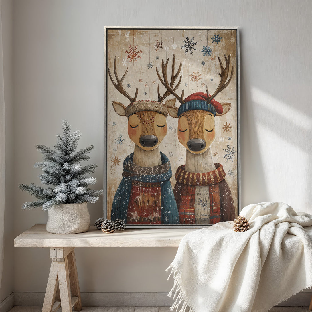Framed Wall Art featuring two charming deer in winter attire. Rustic style with warm, neutral tones and pops of blue and red. Perfect for cozy decor.