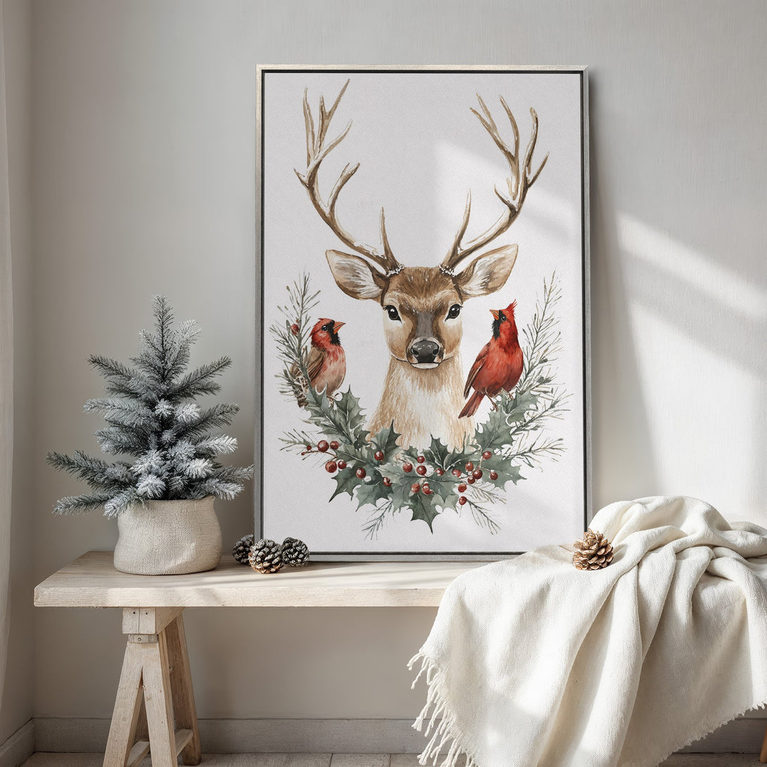 Framed Wall Art featuring a watercolor deer with cardinals and holly. Rustic style, neutral and red color palette. Perfect for cozy winter decor.