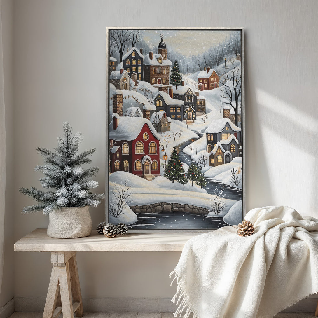 Framed Wall Art: Winter village scene in a cozy, painterly style. Featuring a snow-covered landscape with warm red and neutral tones, perfect for holiday decor.