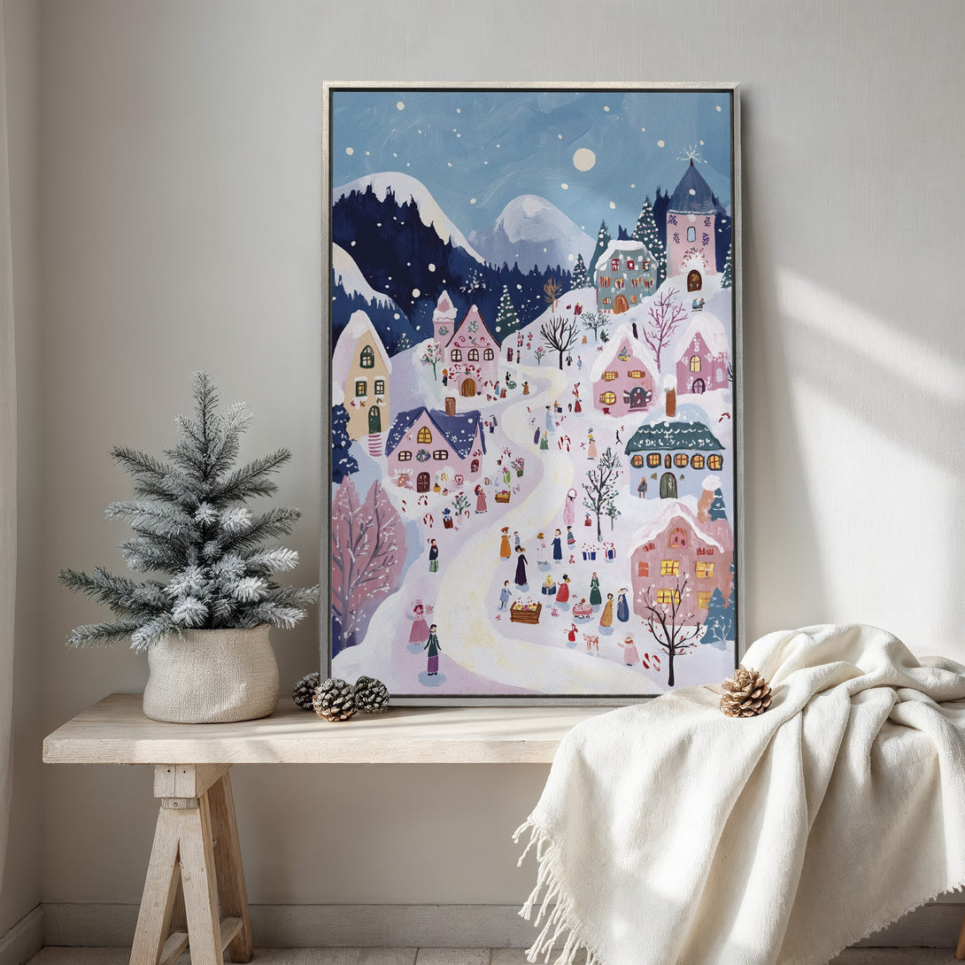 Framed Wall Art: Whimsical winter village scene in pastel blues and pinks. Charming illustration style, perfect for adding cozy holiday decor to any space.