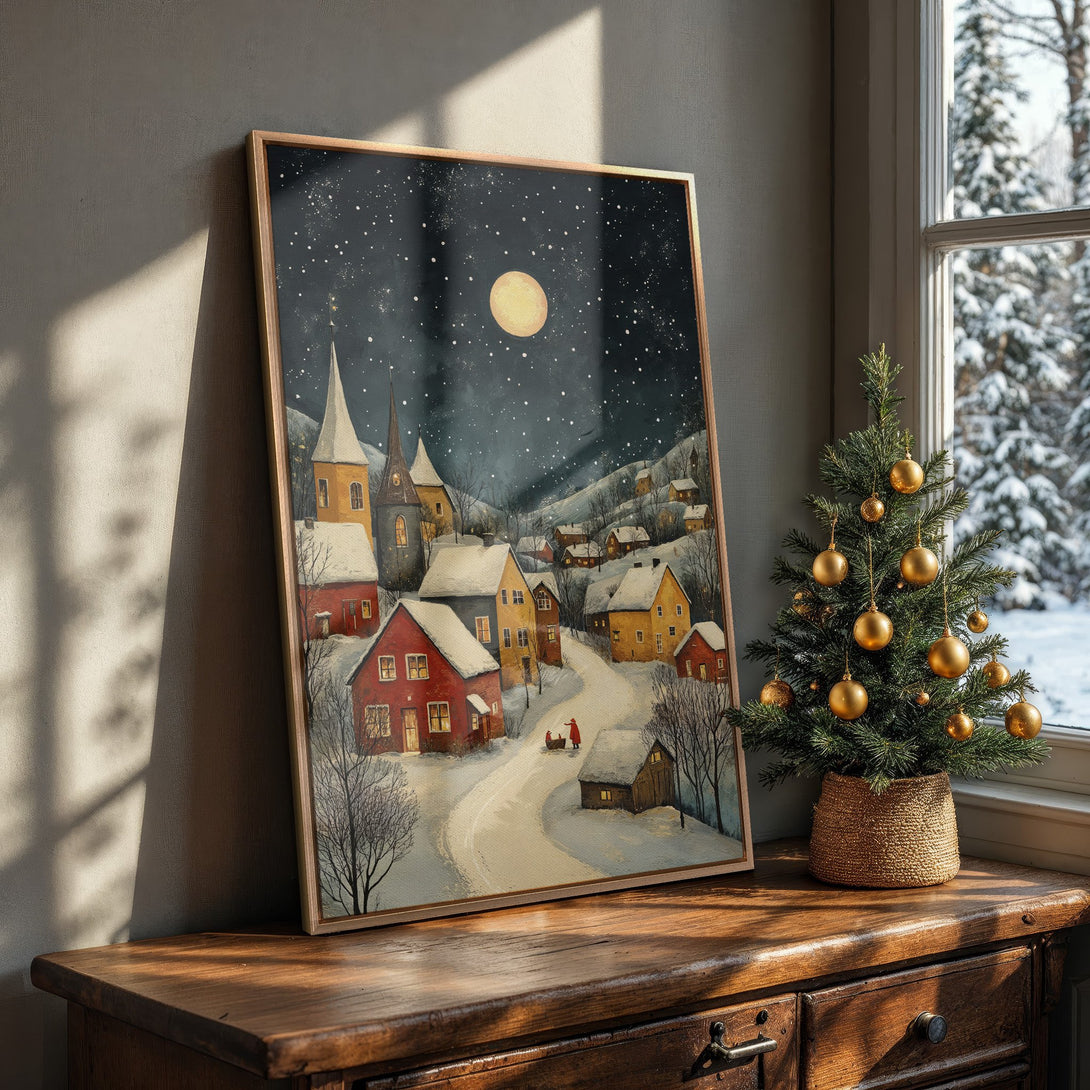 Framed Wall Art featuring a cozy winter village scene in a warm, inviting color palette. Perfect for adding a touch of holiday charm to your home.