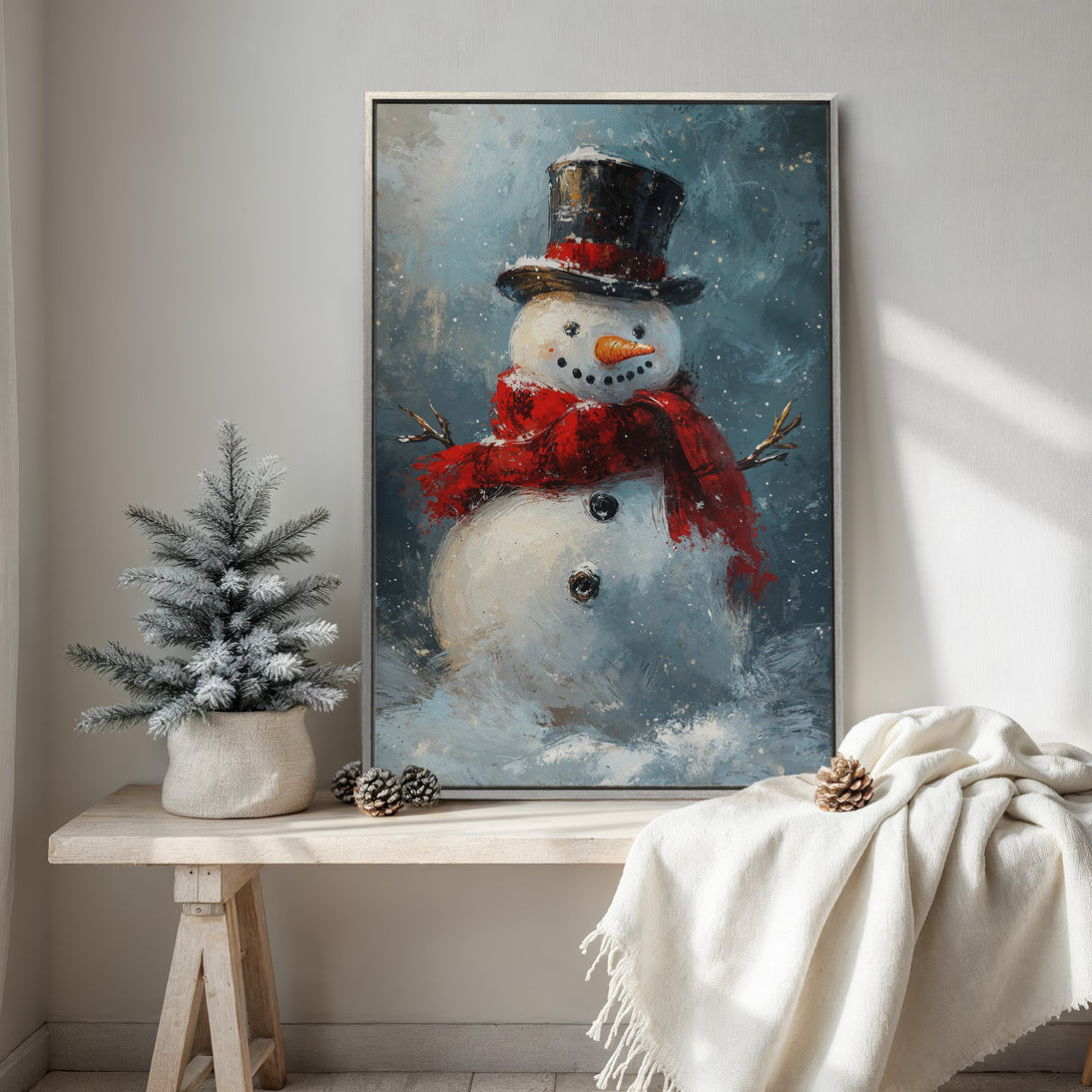 Framed Wall Art: Whimsical snowman painting with a red scarf, set against a blue and white winter backdrop. Perfect for holiday decor, adds a festive touch.