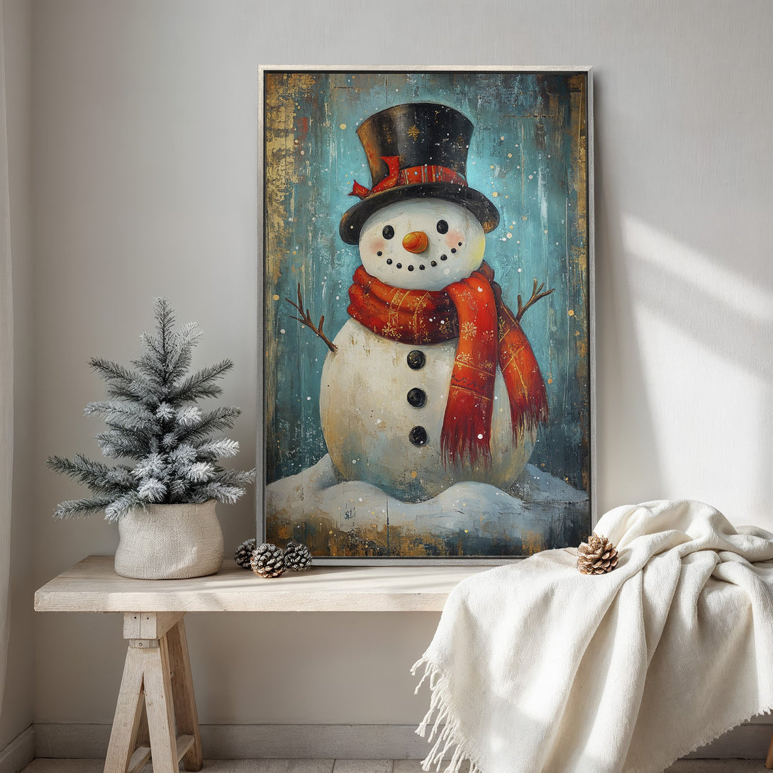 Framed Wall Art: Whimsical snowman painting with a teal and gold background, red scarf, and black top hat. Perfect winter decor!