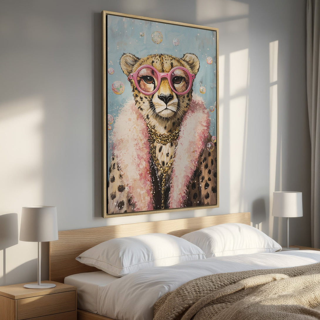 Framed Wall Art: Playful cheetah portrait in pink and gold, displayed in a bedroom. Modern art with a whimsical touch, perfect for a stylish space.