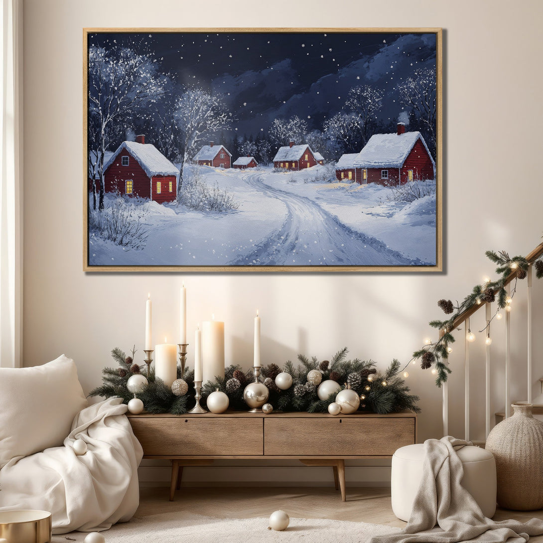 Framed Wall Art: Winter village scene in blue, white, and red. Cozy, inviting landscape canvas print perfect for holiday decor.