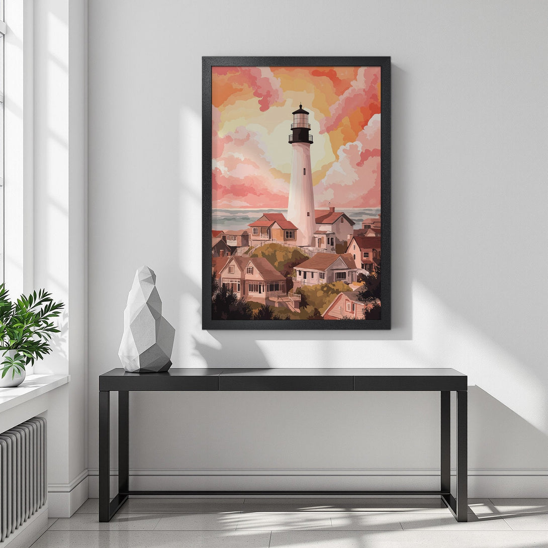 Framed Poster featuring a lighthouse and village, painted in a warm, sunset color palette. Add coastal charm to your space!