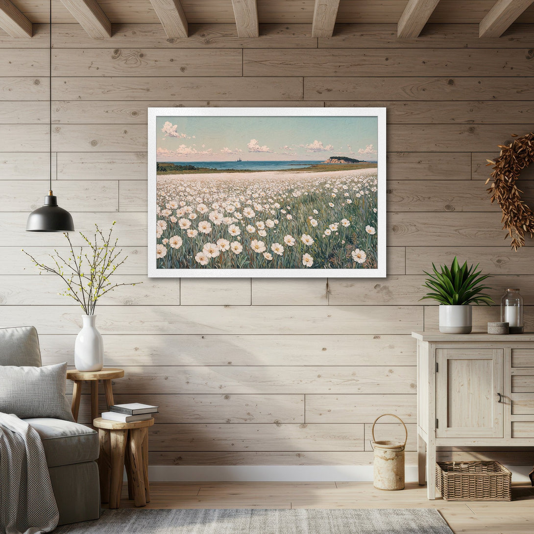 Framed Poster of a field of white flowers by the sea, in a soft, impressionistic style with a calming blue and green color palette. Perfect wall art.