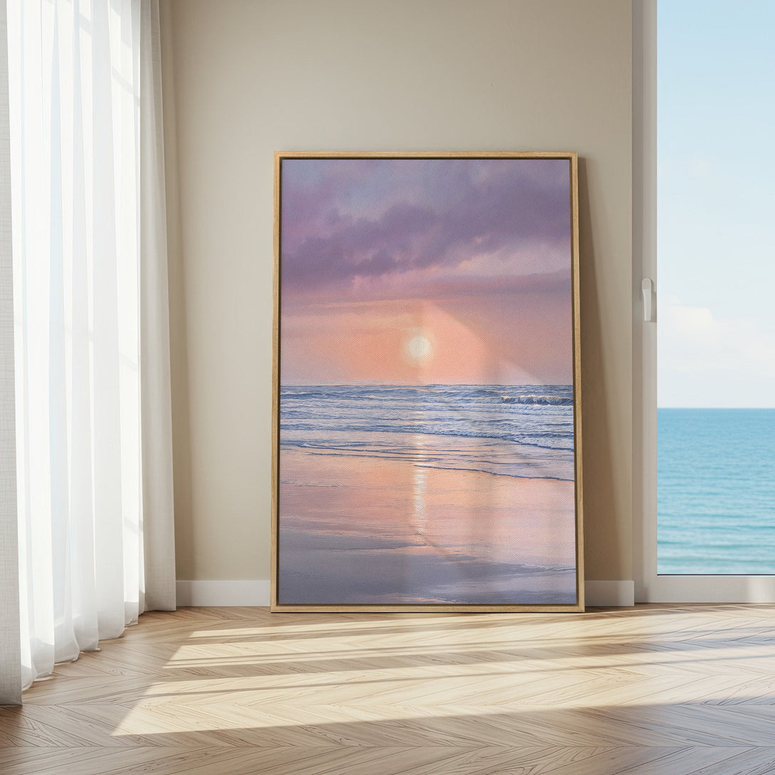 Framed Wall Art: Coastal sunset canvas print in soft pink and blue hues, displayed in a bright interior. Perfect for adding a calming touch to your space.