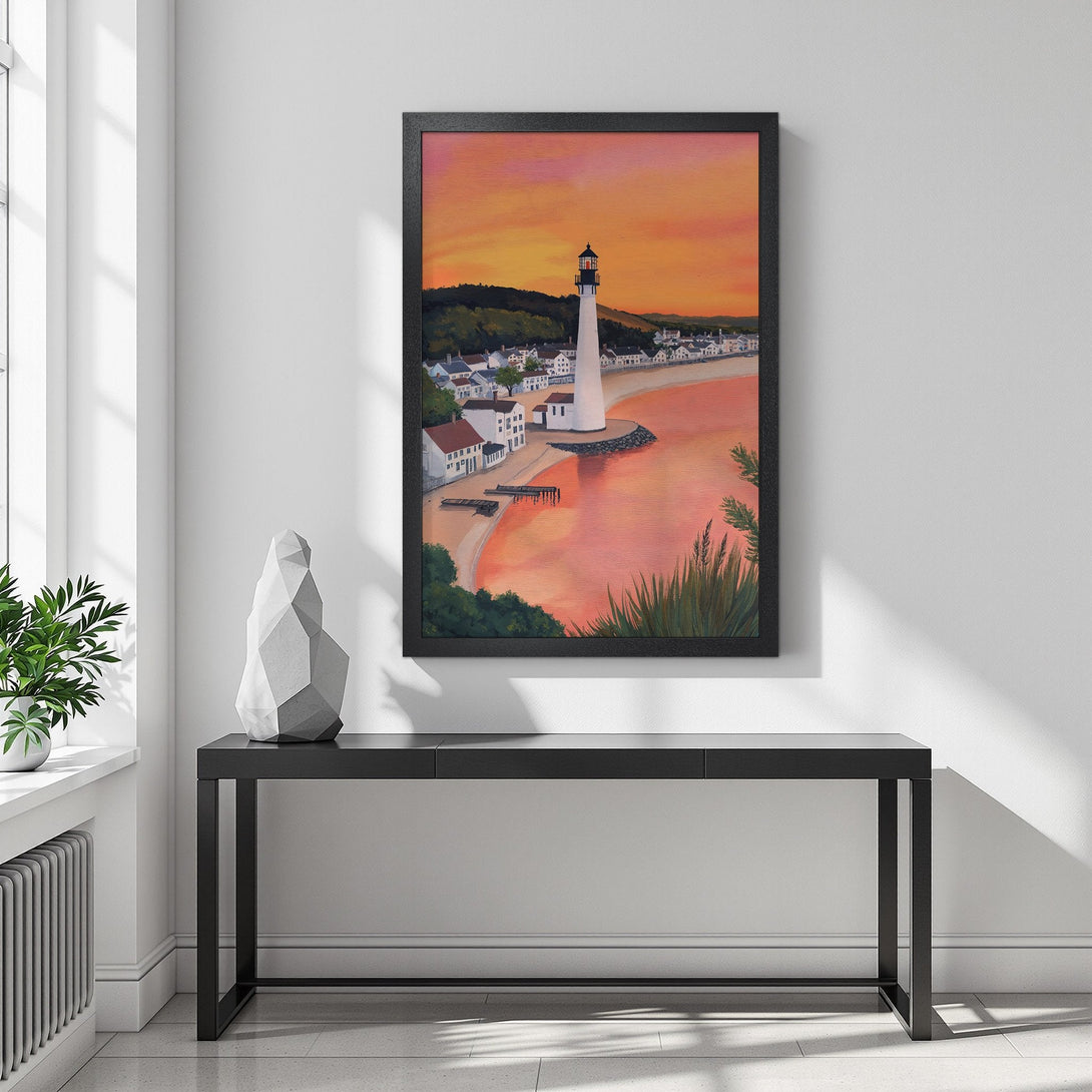 Framed Poster of a lighthouse at sunset. Coastal style art with warm orange and pink hues. Perfect wall decor.