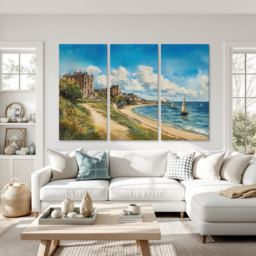 Canvas Print of a coastal landscape painting in blue, beige, and green, displayed above a white sofa. Perfect wall art for your home!
