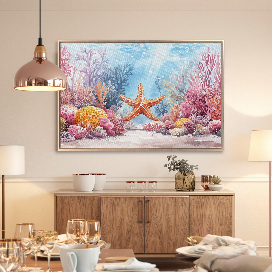Framed Wall Art featuring a watercolor starfish and coral reef scene in vibrant blue, pink, and orange hues. Coastal decor for a serene home.