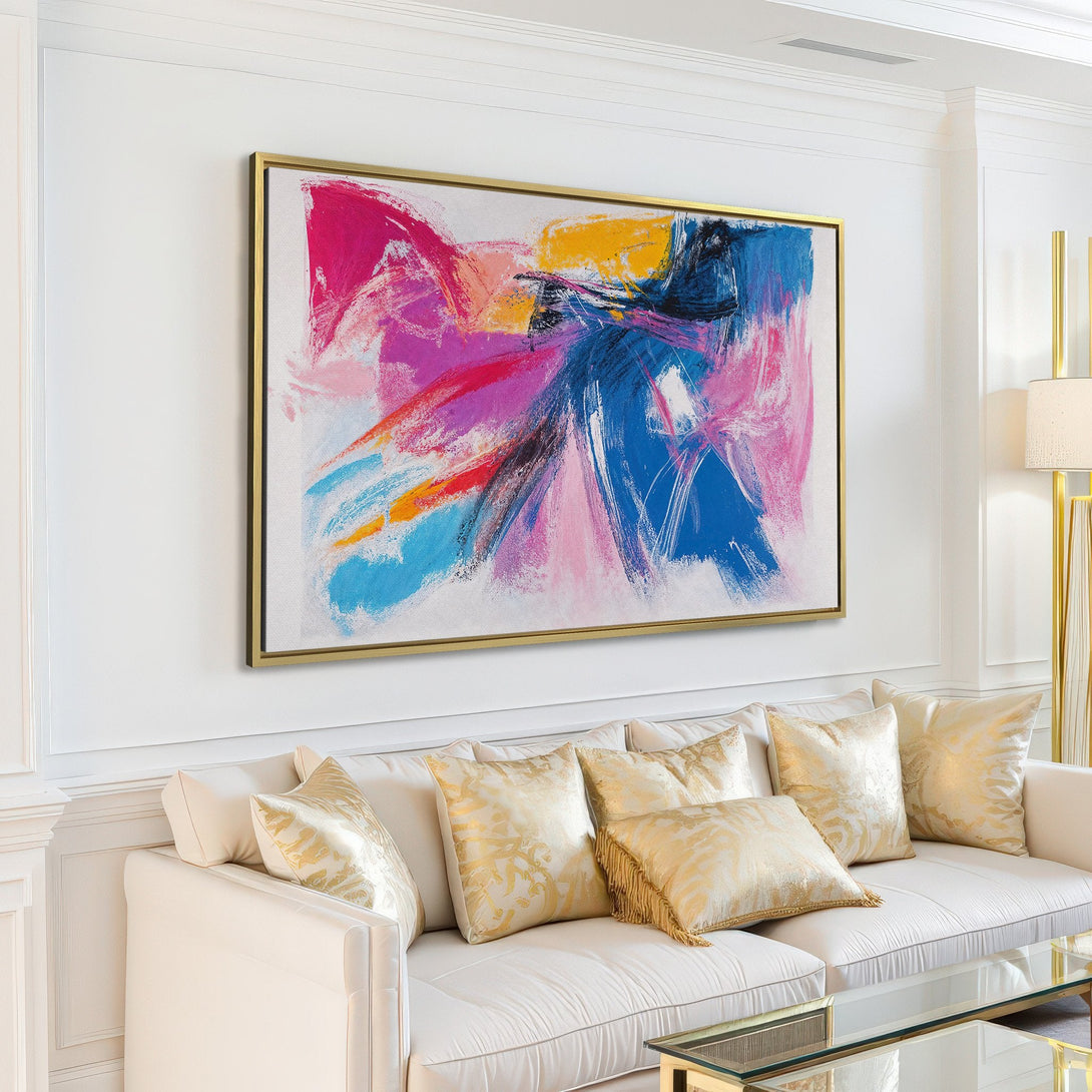 Abstract Canvas Print art in a modern living room. Featuring bold brushstrokes in pink, blue, and yellow. Elevate your space with this vibrant wall art.