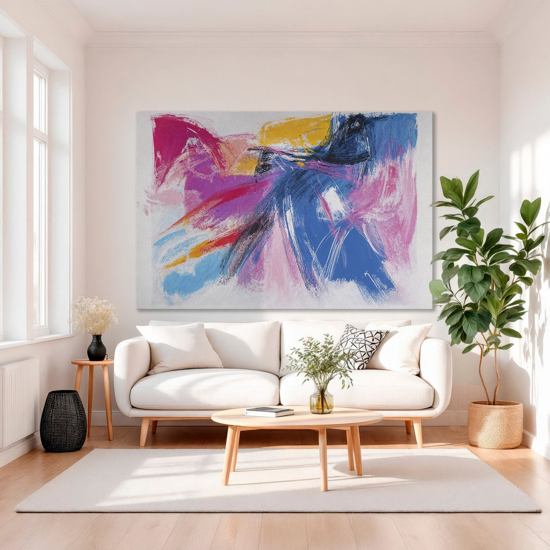 Framed Wall Art: Abstract canvas print with vibrant pink, blue, and yellow brushstrokes. Modern art for living room decor. Adds a pop of color!