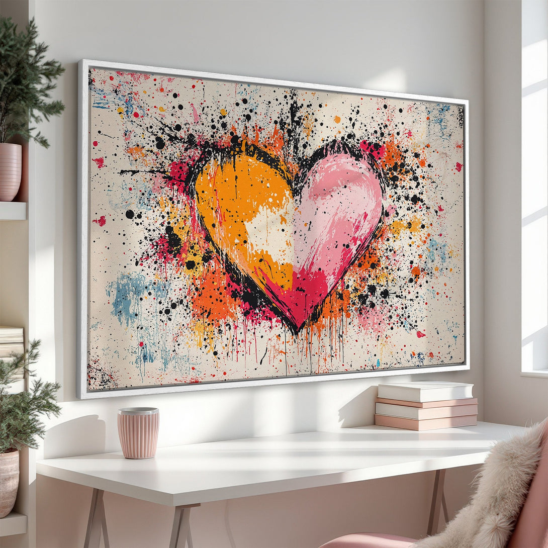 Framed Wall Art: Abstract heart Canvas Print with vibrant splashes of orange, pink, and black. Modern art for a stylish home decor upgrade.
