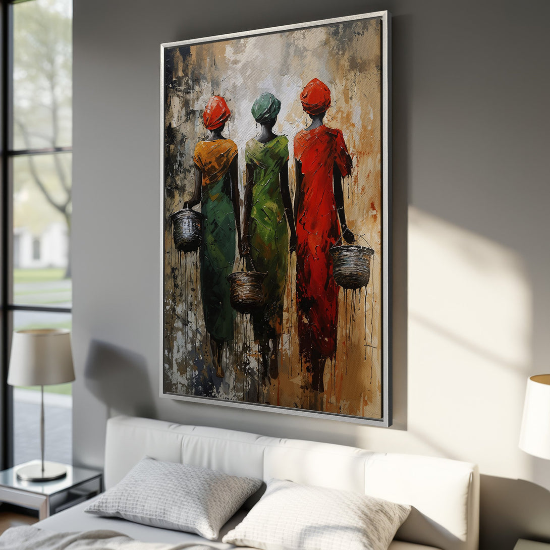 Framed Wall Art: Abstract painting of African women in colorful dresses. Earth tones with pops of red, green, and orange. Perfect for living room decor.