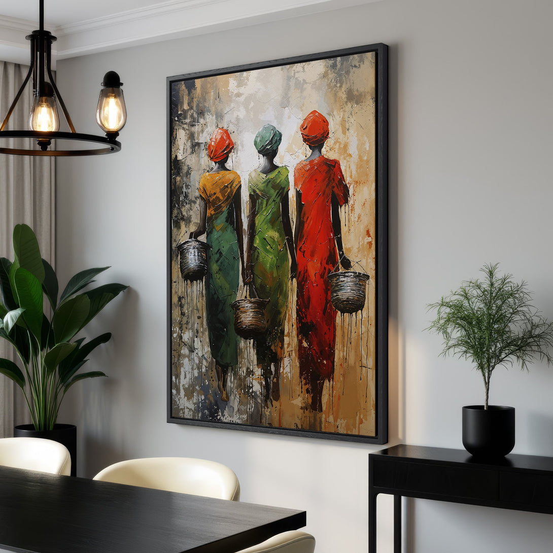Framed Wall Art featuring three women in colorful dresses. Abstract style with warm earth tones and pops of red, green, and yellow. Perfect for any interior.