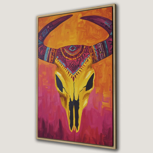Framed Wall Art: Bold, colorful canvas print of a stylized bull skull. Warm orange, pink, and yellow palette. Perfect for adding a pop of art to your space.