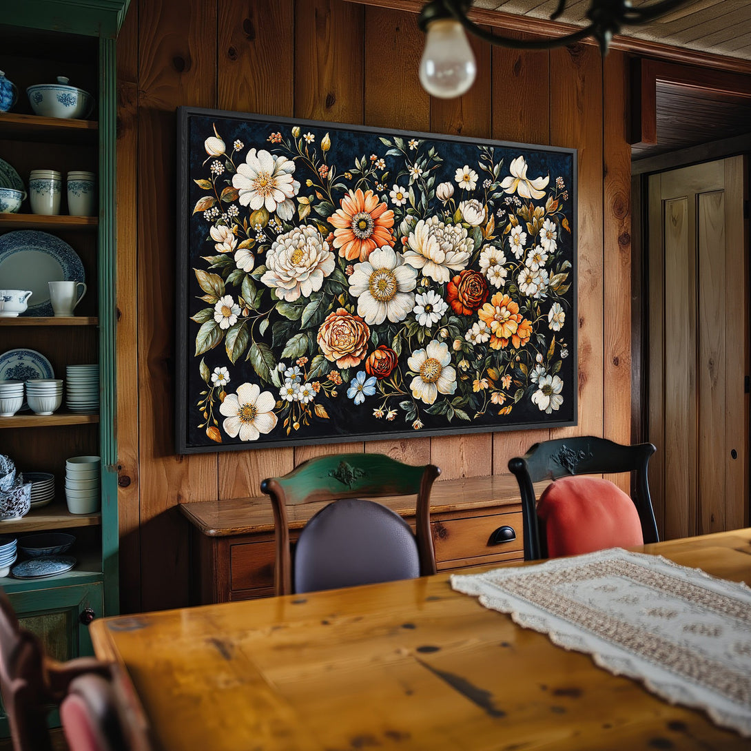 Framed Wall Art: Floral Canvas Print in a rustic dining room. Features a dark background with white, orange, and green flowers. Adds a touch of elegance.
