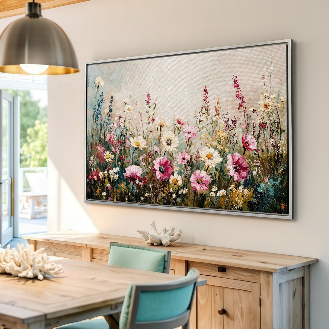 Framed Wall Art: Floral canvas print in a light-filled interior. Features a colorful wildflower meadow in a soft, painterly style with pink, white, and green hues.