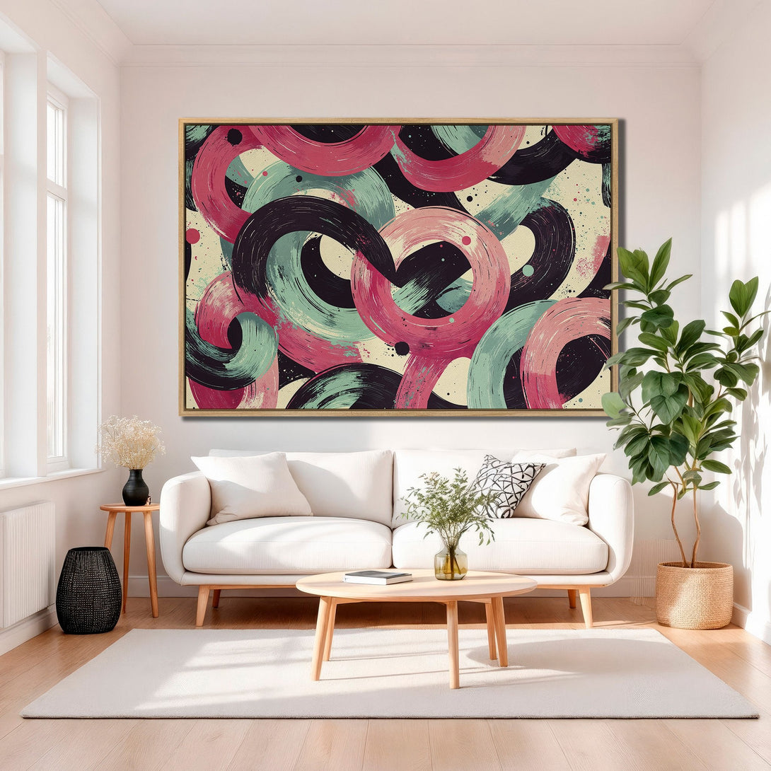 Framed Wall Art featuring abstract brushstroke circles in pink, teal, and black. Modern art canvas print adds a pop of color to any living room.