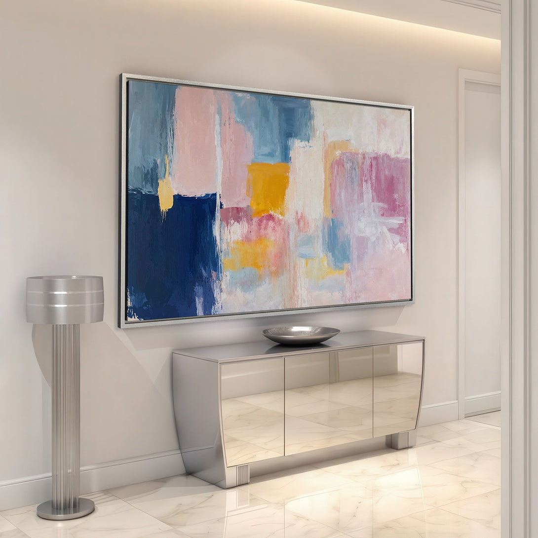 Framed Wall Art: Abstract canvas print in a modern interior. Features a colorful palette of blues, pinks, and yellows. Perfect for adding a pop of color!