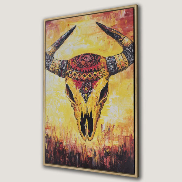 Framed Wall Art: Tribal bull skull canvas print in warm yellow, orange, and red tones. Add a touch of bohemian style to your home decor.