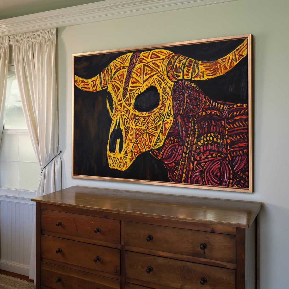 Framed Wall Art: Abstract bull skull in yellow, orange, and red hues. Bold, tribal-inspired design on black background. Perfect for modern home decor.