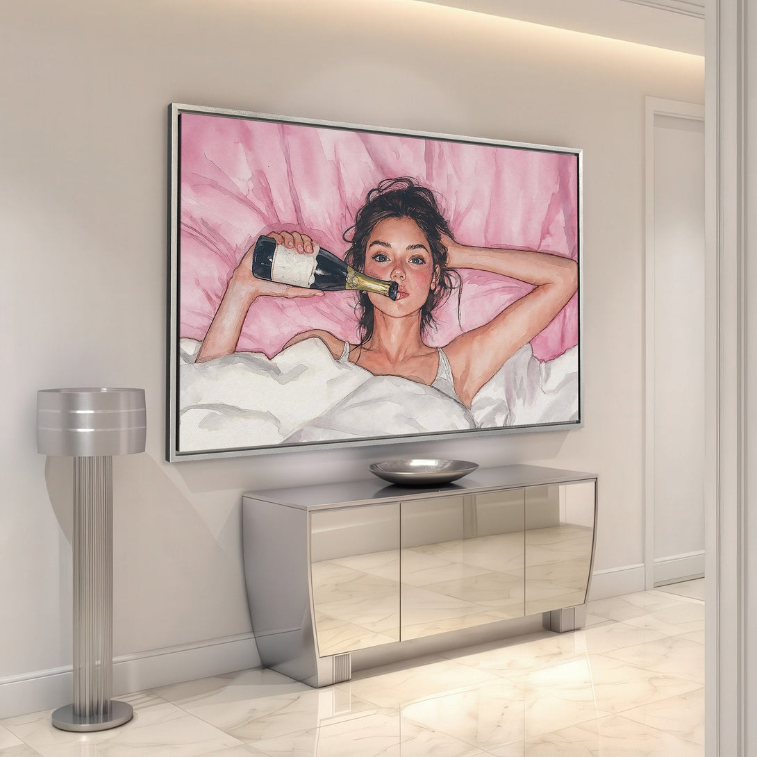 Framed Wall Art: Watercolor painting of a woman in bed with champagne. Pink and white color palette. Perfect for modern home decor.