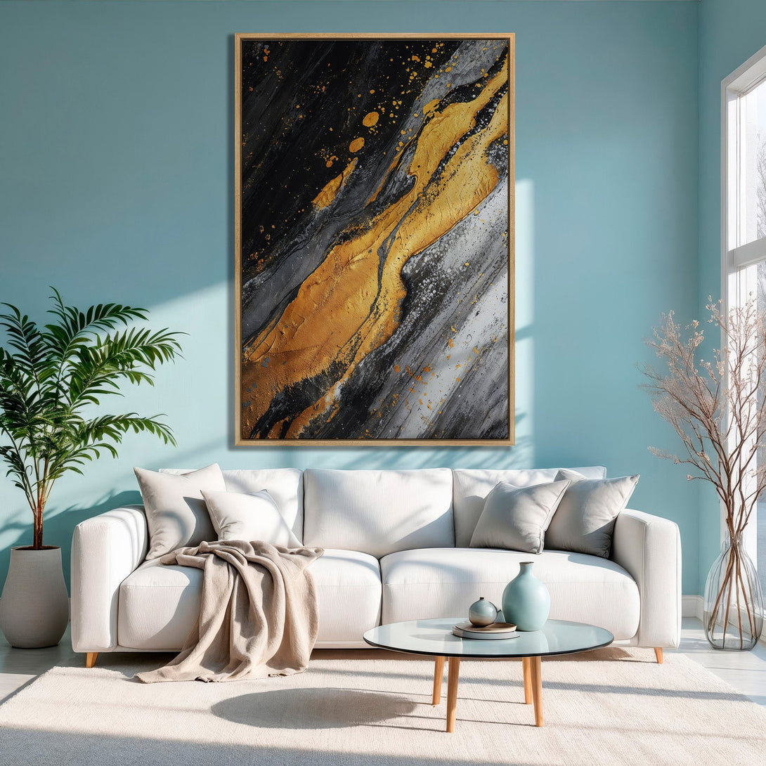 Framed Wall Art featuring abstract gold, black, and gray art. Modern canvas print adds a touch of luxury to any living room with its elegant color palette.
