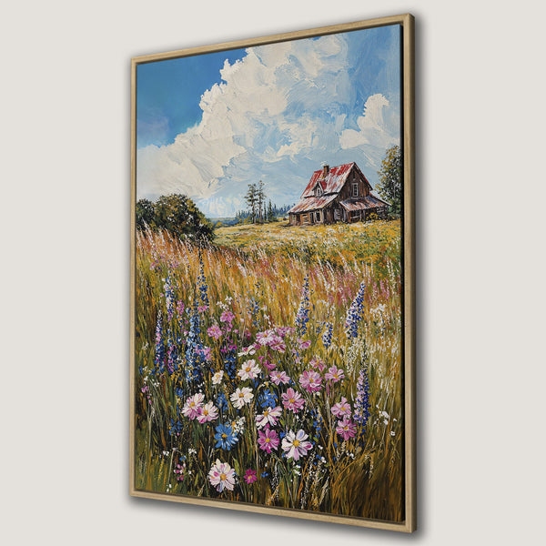 Framed Wall Art: Rustic landscape Canvas Print featuring a charming farmhouse, wildflowers, and a vibrant blue sky. Warm, earthy tones with pops of color.