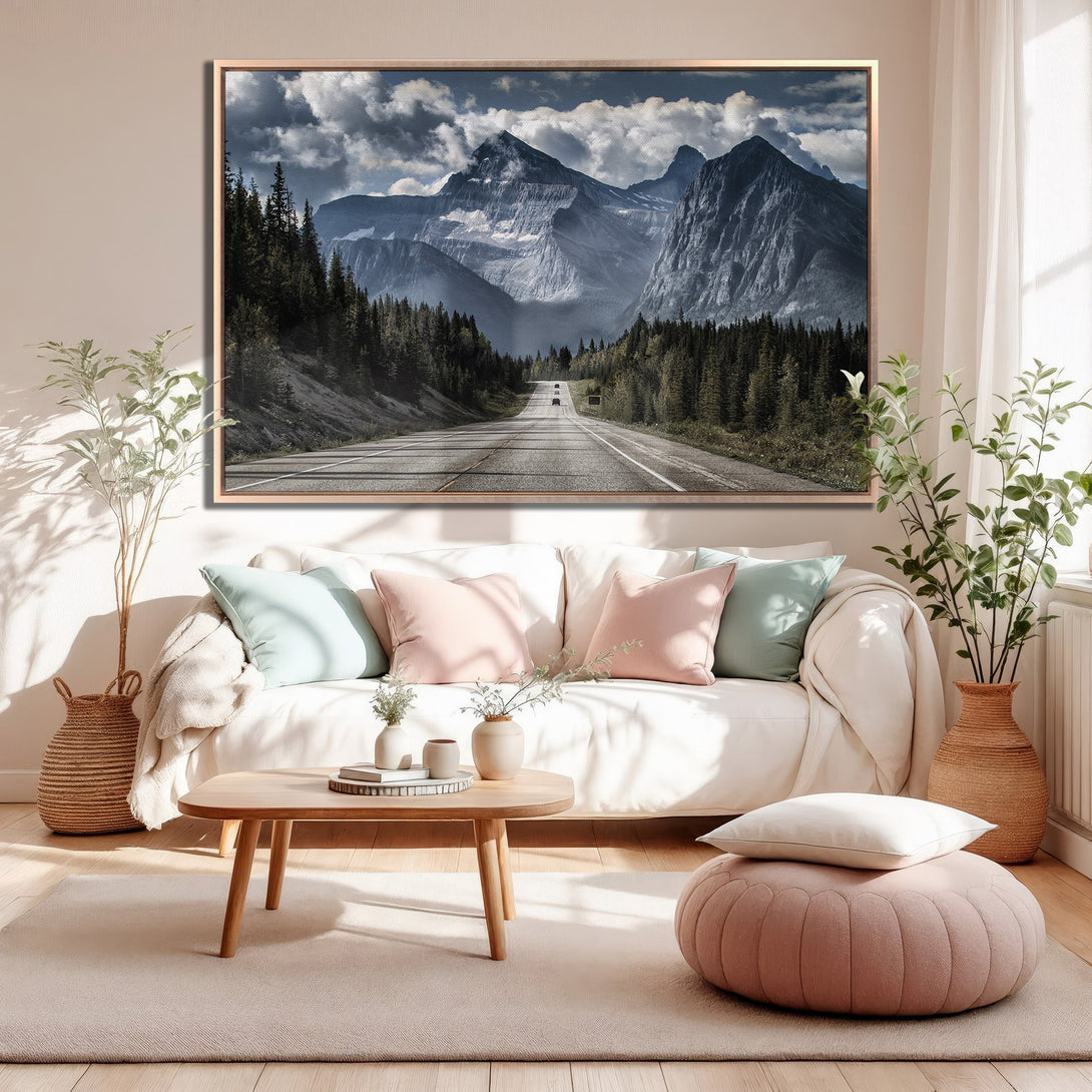 Framed Wall Art featuring a scenic mountain road, displayed in a cozy living room. Earthy tones and cool blues create a calming aesthetic.